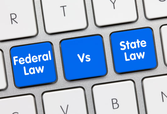 federal law vs state law illustrated by keys on a computer keyboard