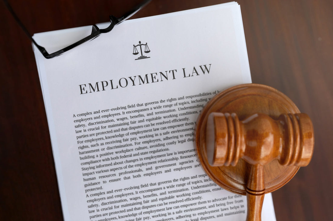 Employment law documents with glasses and a gavel.