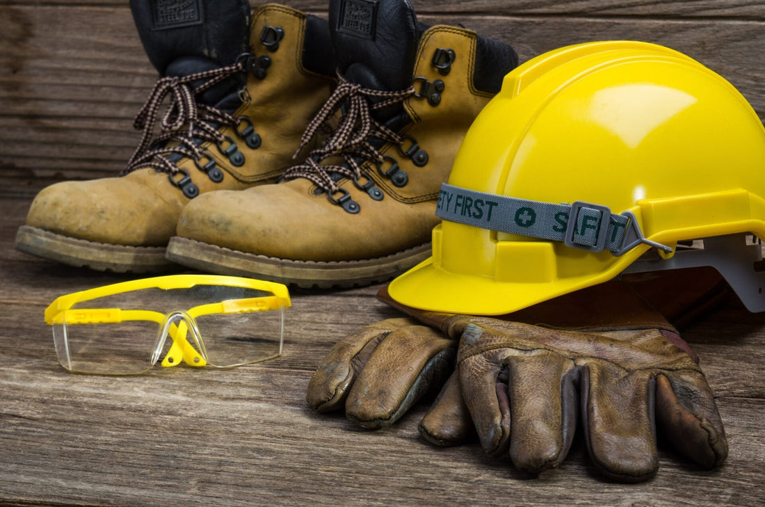 Image of hard hat, safety googles, leather gloves, and work boots
