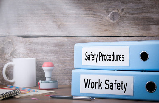 Safety Procedures and Work Safety notebooks on desk