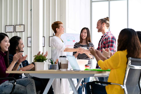 Group of employees welcome each other in the workplace