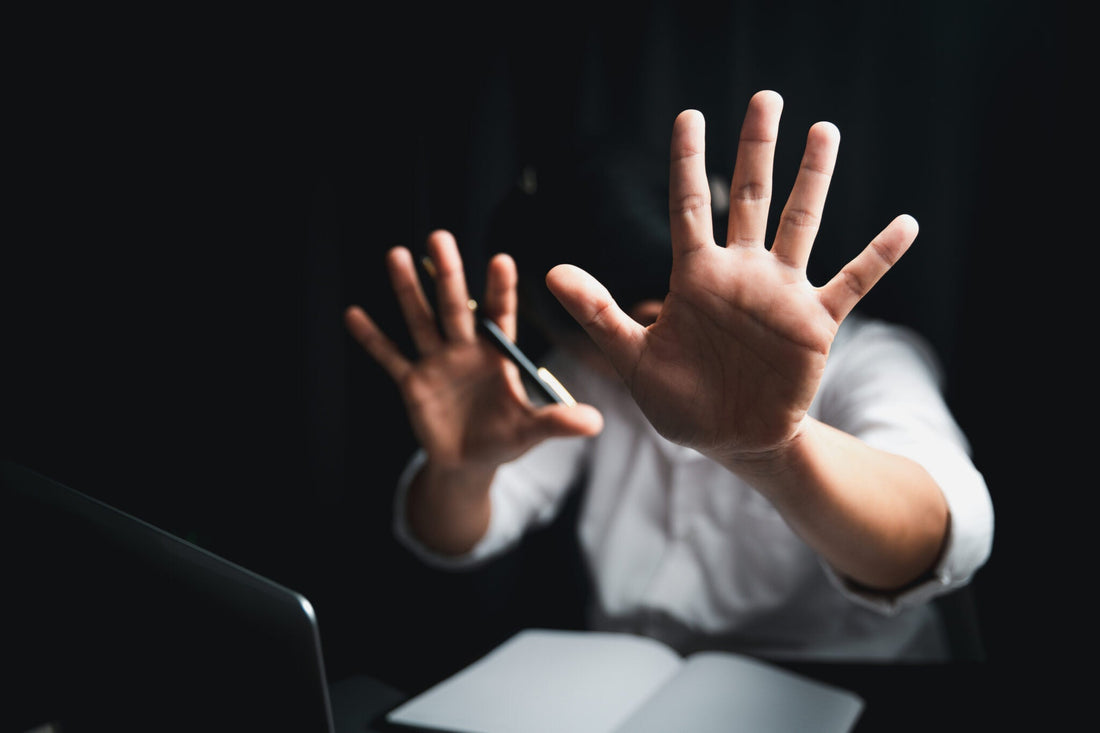 person holding out hands to keep someone away
