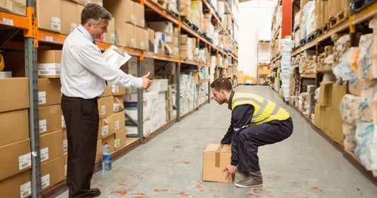 Warehouse worker practicing lifting techniques
