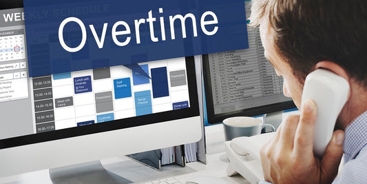 overtime man on phone working on computer 