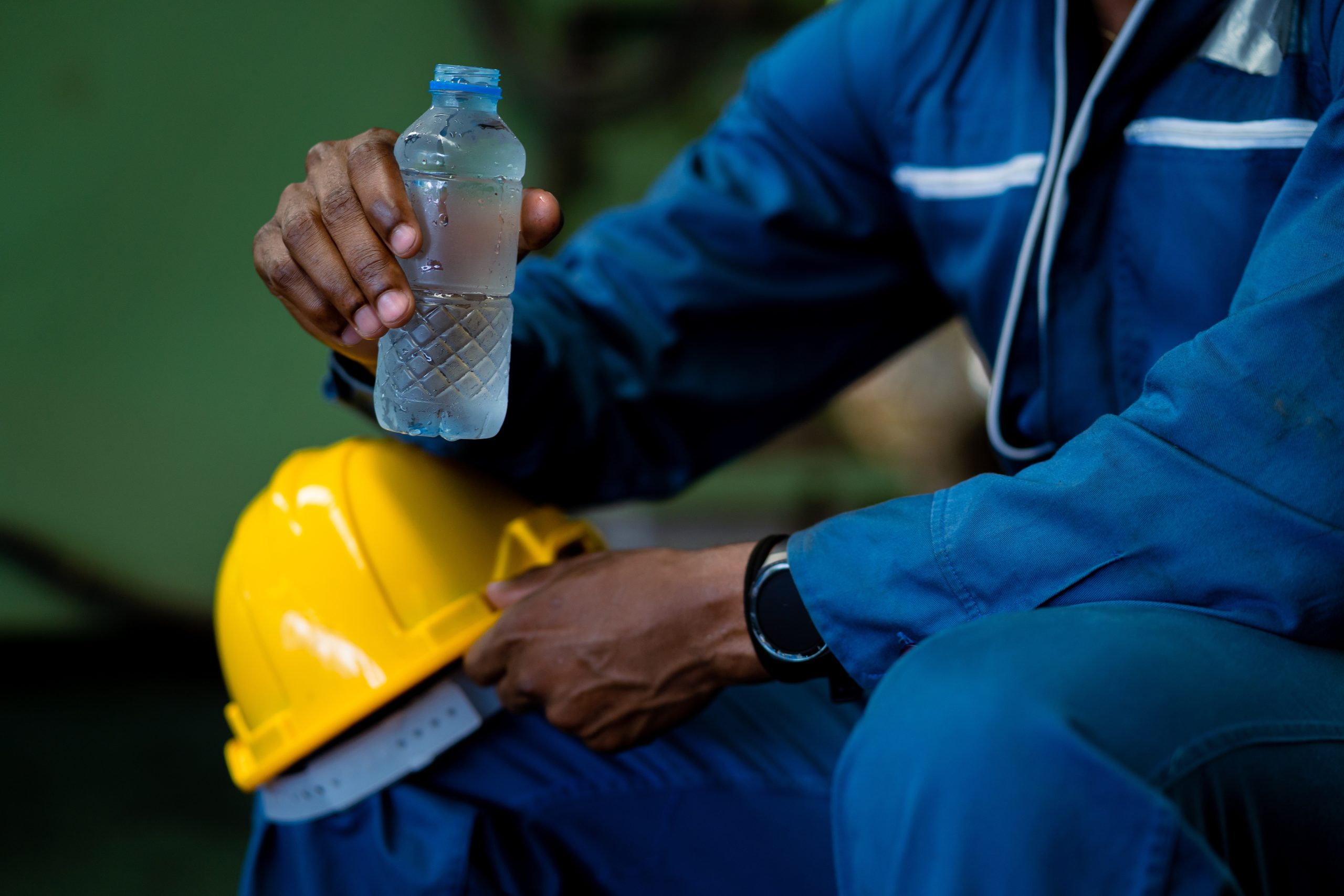 Worker drinking water to cool off.